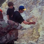 Geochemists from Guadeloupe Observatory and members of Montserrat Defense Force sampling gases at Tar River soufriere, Aug 1995.