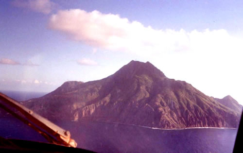 North coast of Saba from cockpit of commercial airliner approaching landing strip.